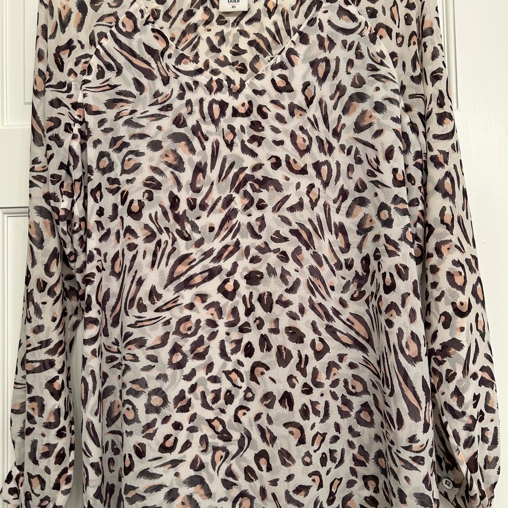 CAbi Black and White Animal Print Blouse
Length 26” 
Pit to Pit 20”